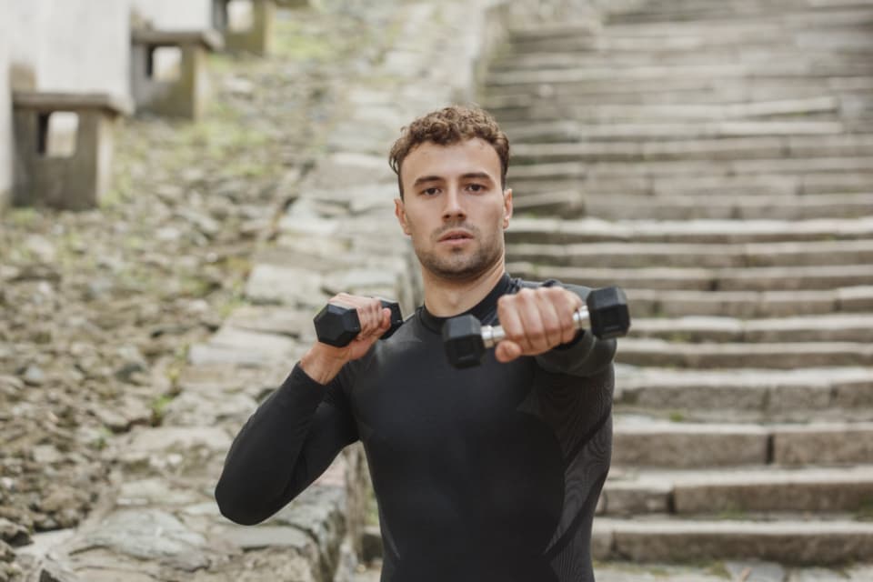 Portrait of coach Dario Venn holding dumbbells